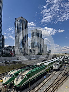 Commuter Trains on Tracks with Buildings in Background