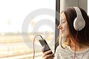 Commuter traveling into a train listening to music