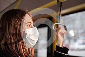 Commuter wears a protective mask in public transport.