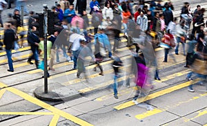 Commuters crossing a busy crosswalk photo