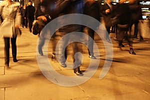 Commuters on London Bridge at night