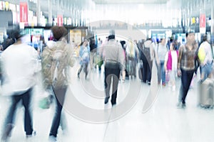 Commuters in motion blur, airport interior
