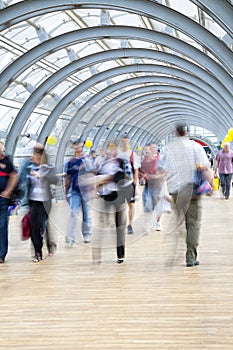 Commuters rushing in corridor, motion blur