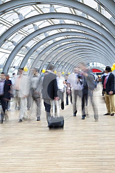 Commuters rushing in corridor, motion blur