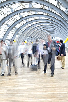 Commuters rushing in corridor, motion blur