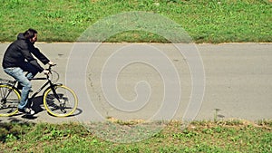 Commuting to work on a bicycle. Man riding bicycle on a bike path marked