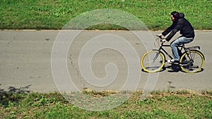 Commuting to work on a bicycle. Man riding bicycle on a bike path marked
