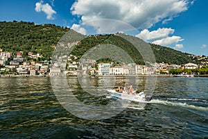 Como, ITALY - August 4, 2019: Apartments, villas, hotels on the green forested mountainsides near Lake Como. Beautiful Italian