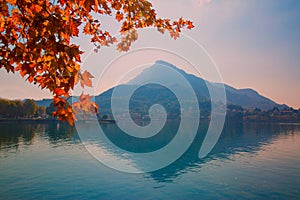 Como lake in Italy, beautiful fall time, red leaves and alp mountains