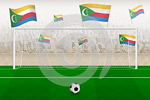 Comoros football team fans with flags of Comoros cheering on stadium, penalty kick concept in a soccer match