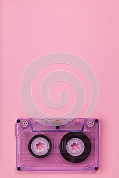 Compact audio tape cassette on pink background