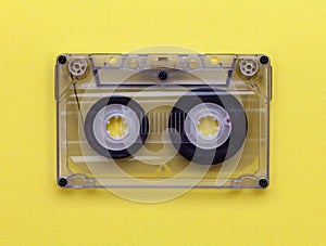 Compact audio tape cassette on yellow background