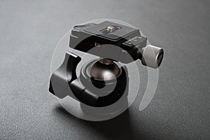 A compact ballhead tripod head in a dark background photo