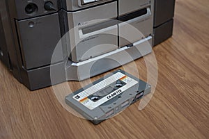 Compact cassette and audio tape player on table wood background