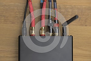 Compact class D amplifier with tube preamp stage and connected audio cables, modern high power small audio solution
