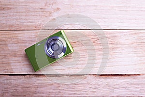 Compact Digital Camera isolated on wooden Background