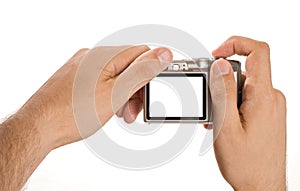 Compact digital photo camera held in hands