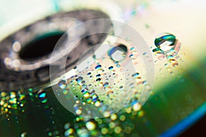 Compact disc in the background and close-up raindrops