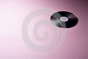 One compact disc on pink background