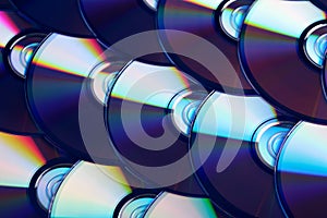 Compact discs background. Several cd dvd blu-ray discs. Optical recordable or rewritable digital data storage.