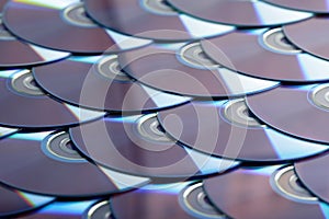 Compact discs background. Several cd dvd blu-ray discs. Optical recordable or rewritable digital data storage.