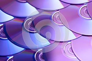 Compact discs background. Several cd dvd blu-ray discs. Optical recordable or rewritable digital data storage.