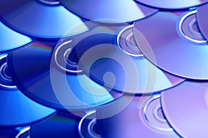 Compact discs background. Several cd dvd blu-ray discs. Optical recordable or rewritable digital data storage.