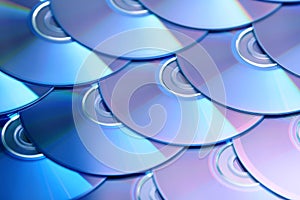 Compact discs background. Several cd dvd blu-ray discs. Optical recordable or rewritable digital data storage.