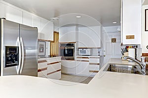 Compact kitchen room with white cabinetry photo