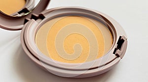 Compact powder for natural color make-up close-up isolated on a white background