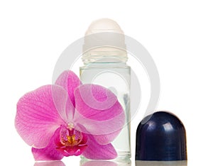 Compact roll deodorant and orchid flower on white.