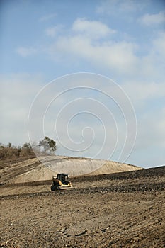 Compact track loader working under the blue sky on Sucre, Ecuador