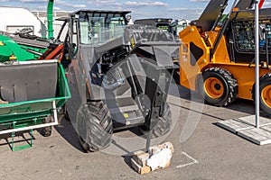 Compact wheeled tractor with jackhammer. Maneuverable equipment for the destruction of monolithic objects. Sale of new photo