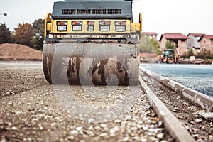 Compactor on construction site. Road paving and compacting during highway construction