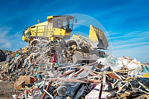 Compactor at a landfill processing municipal waste