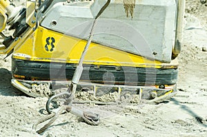 Compactor machinery at street reconstruction site closeup.