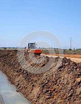 Compactor pressing earth