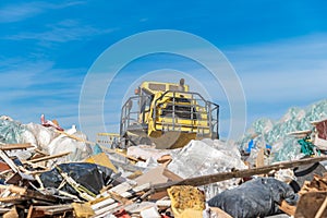 Compactor processes waste at a landfill