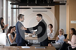 Company boss congratulate promoted employee staff applauding