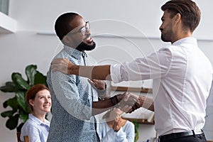 Company boss congratulating handshaking with successful employee