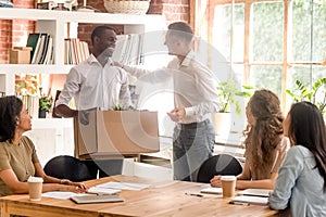 Company boss and staff gathered in office greeting newcomer employee