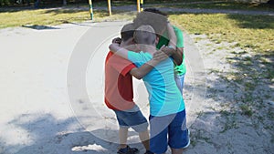 Company of boys footballers preparing for match, ritual before game, hugging