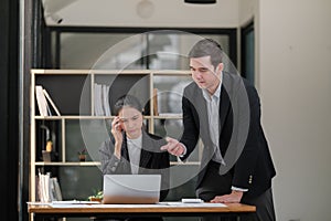 Company CEO and Top Manager Talking, Using Laptop Computer in office. Two Successful Professional People Brainstorm