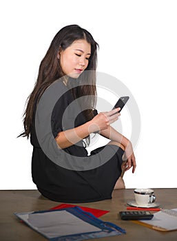 Company corporate isolated portrait of young beautiful and successful Asian Chinese business woman using mobile phone working at o