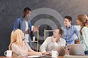 Company coworkers discussing ideas in office