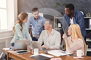 Company coworkers discussing ideas in office