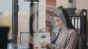 Company employee looking at papers and computer