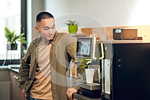 Company employee preparing a caffeinated beverage at work