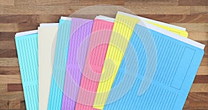 Company employee throws colorful folders on wooden table