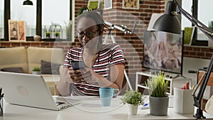 Company employee using smartphone to text messages